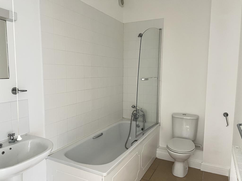 Lot: 6 - TWO-BEDROOM FLAT FOR INVESTMENT OR OCCUPATION - White bathroom suite with white tiles and painted walls
